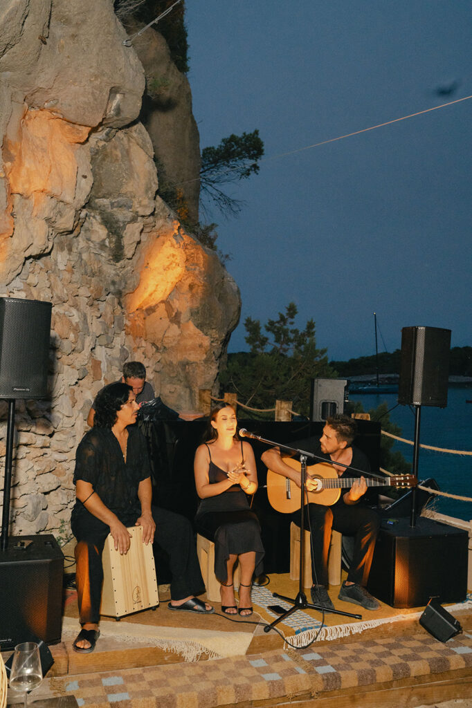 Elena and Mo dancing with flamenco musicians during their welcome party